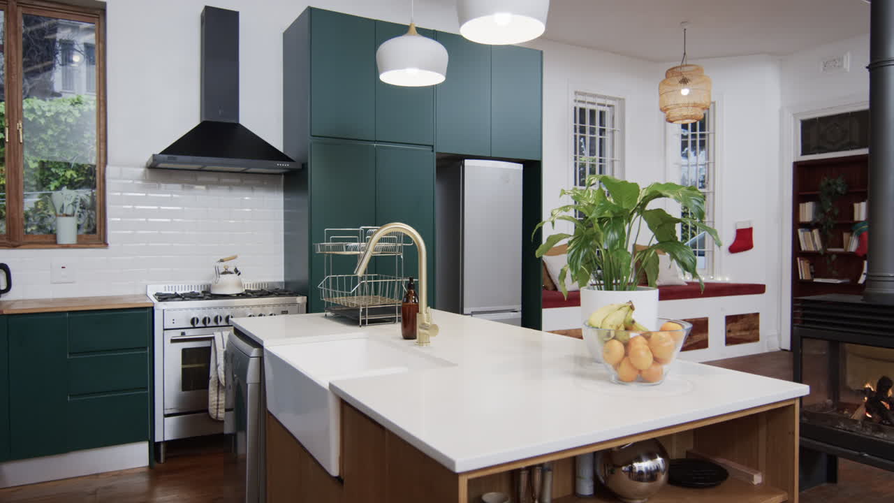 General view of modern kitchen with countertop, cupboards and kitchen equipment, slow motion