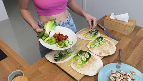 woman preparing healthy wraps with vegetables