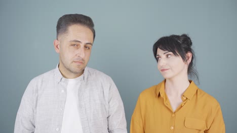 Couple-making-negative-gesture-at-camera.