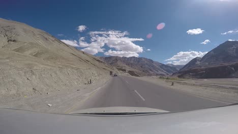 driving through ladakh region in india. arid landscape with mountains.