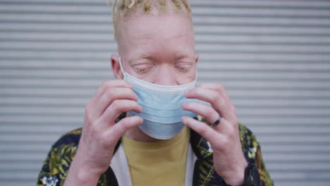 Albino-african-american-man-with-dreadlocks-wearing-face-mask