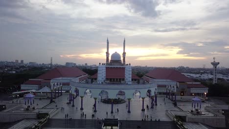 reversal drone shot of the great mosque of central java (majt) in suset time. th sun is orange and the weather is cloudy