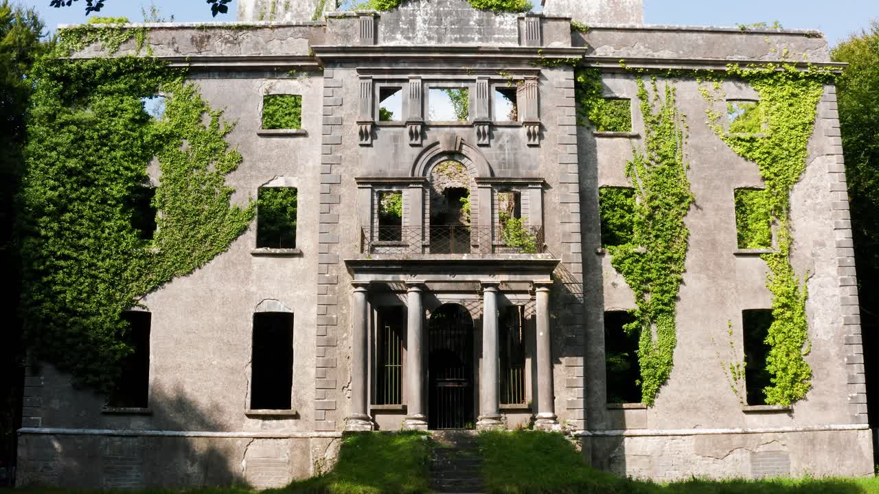 Forward Approach of Ivy-Covered Moore Hall Ruins Framed by Tree Branches with Sunlight Casting on Historic Walls