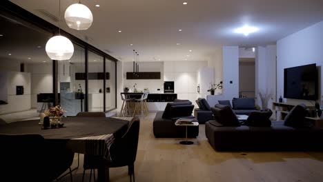 Slow-establishing-shot-of-a-minimal-black-and-white-kitchen-and-living-room-in-a-villa