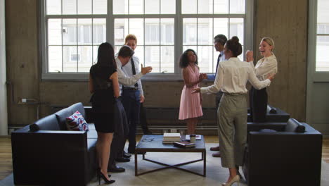 Female-boss-and-colleagues-celebrating-at-a-casual-meeting