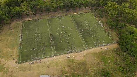 school boys playing training in small green football soccer fields