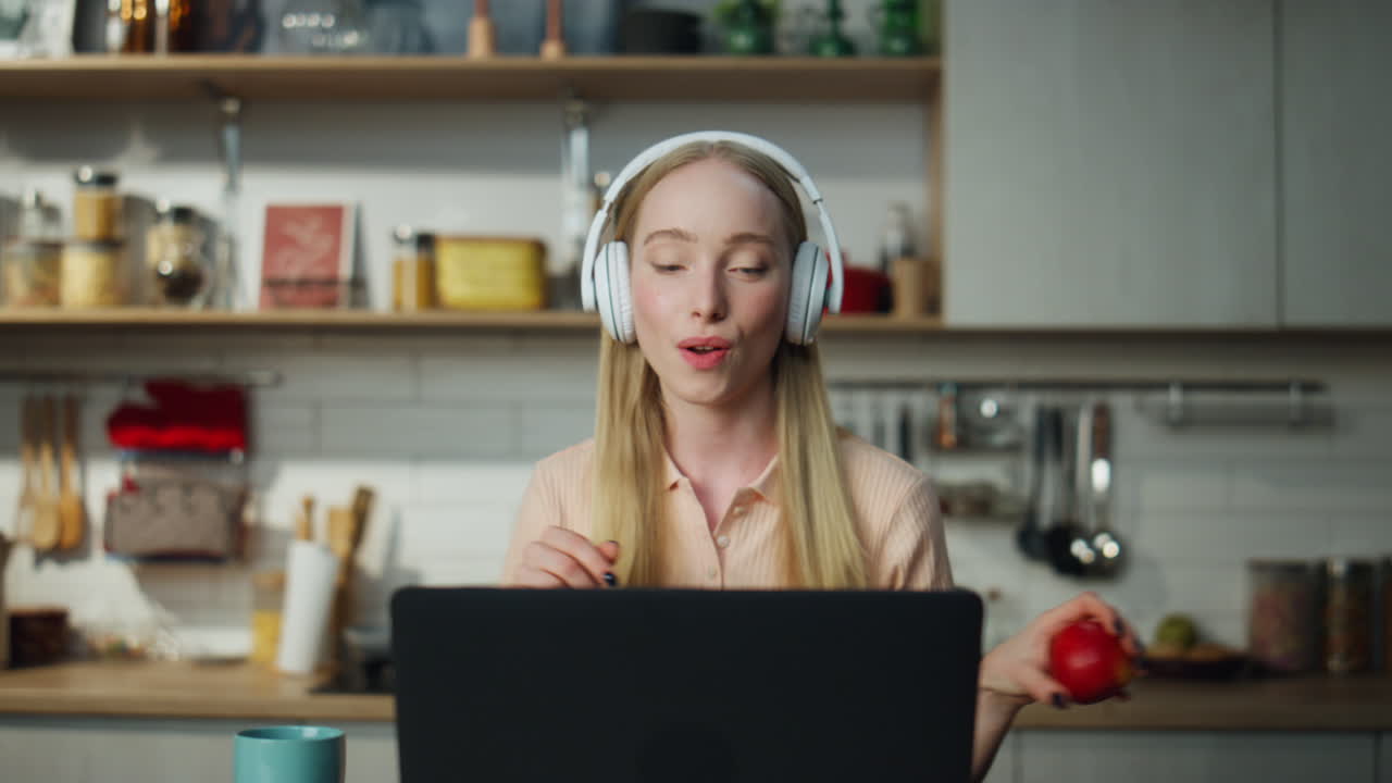 Woman freelancer dancing laptop in headphones close up. Girl resting from work.