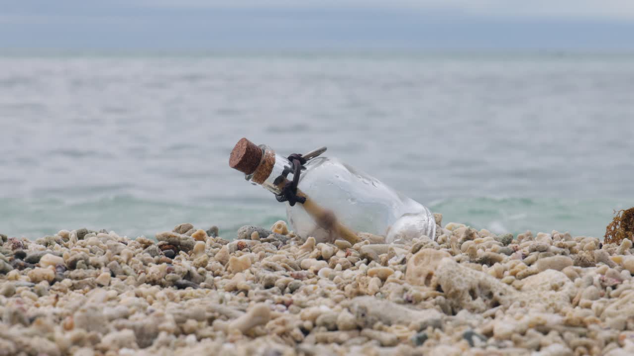 Message in the bottle on a sand beach