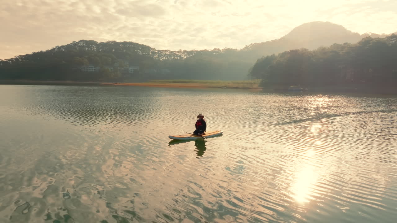 Sunrise Paddleboarding on a Serene Lake