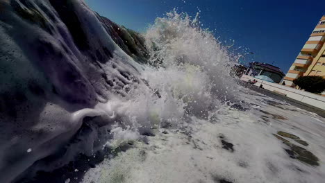 A Close Up Shot Of Sea Waves Splashing Towards The Beach And Forming White Foam