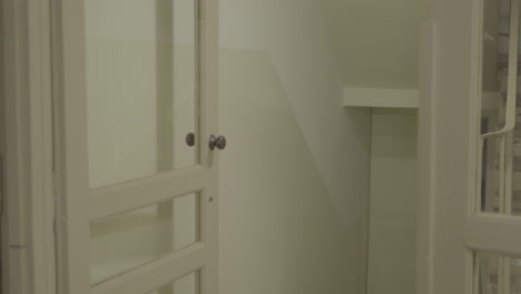 classic white wooden door partially open to a corridor