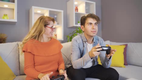 mother and son playing video game with game consoles.