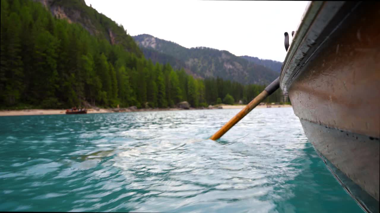 Creative shot of the exterior of a wooden rowing boat on a blue mountain lake, the Lago di Braies in Italy
