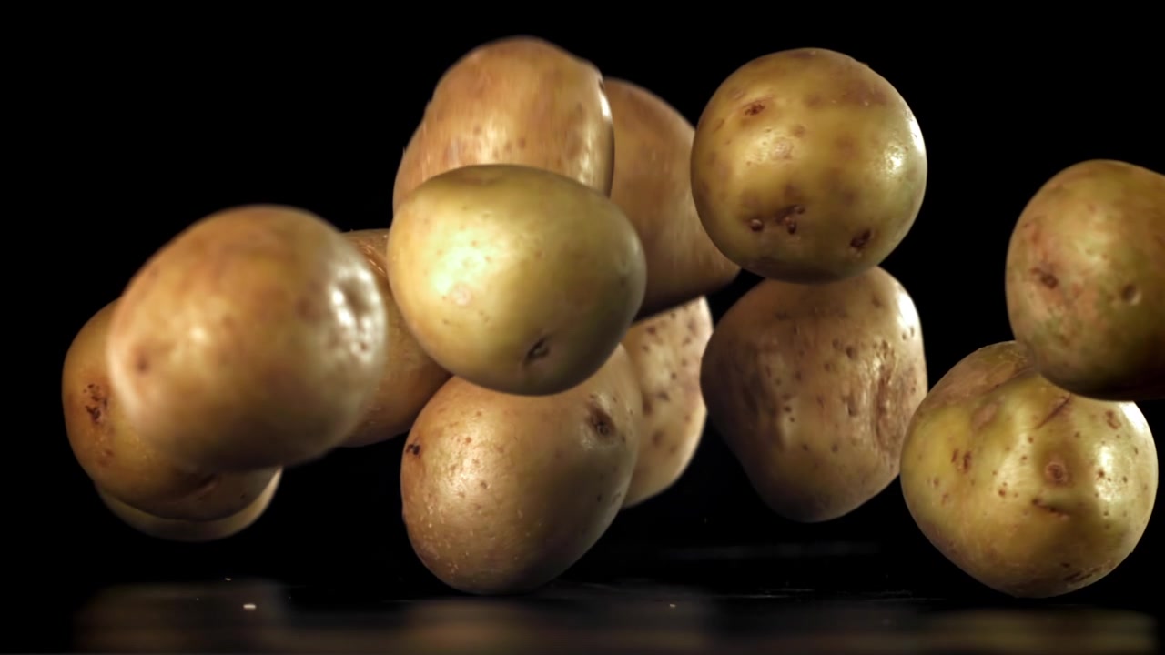 Patate Fresche che Cadono al Rallentatore su Sfondo Nero
