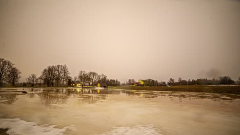 day to night timelapse of cottages by stream over rainy sky