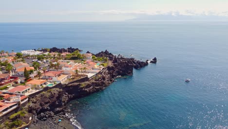 a slow cinematic shot overlooking the bay and beach of la arena in santiago del teide on tenerife of the canary islands