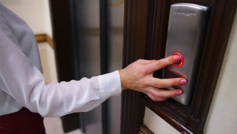 woman entering the elevator. young businesswoman in modern elevator at hotel