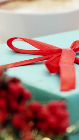 close-up of coffee cup with christmas decoration and gift