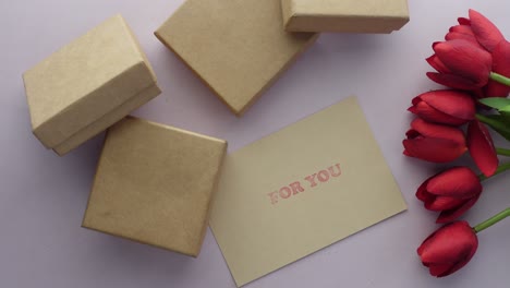 top view of gift box and tulip flower on  background