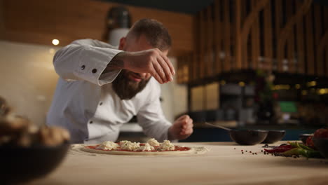 professional chef making pizza dinner recipe in fine italian restaurant kitchen.