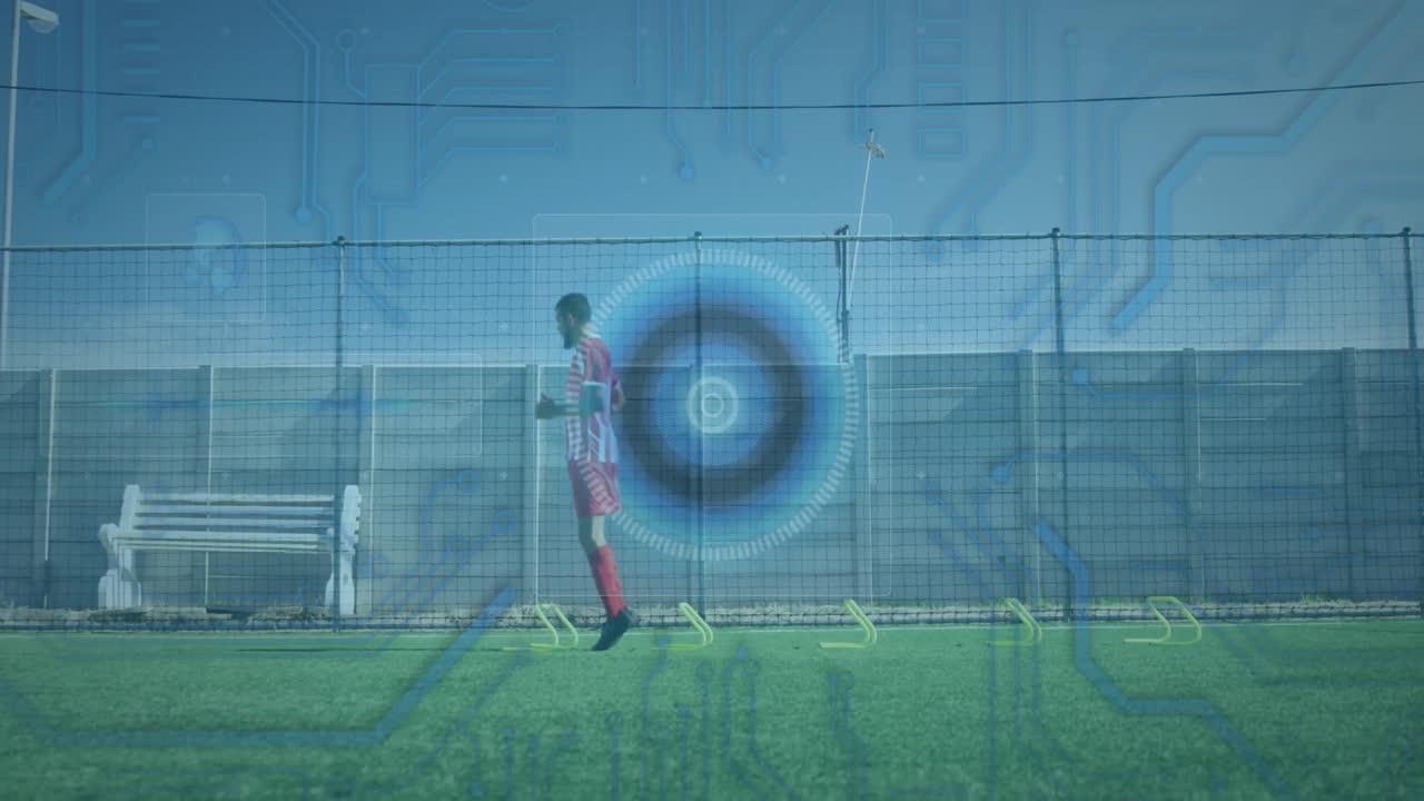 Microprocessor connections and round scanner against male soccer player practicing on grass turf