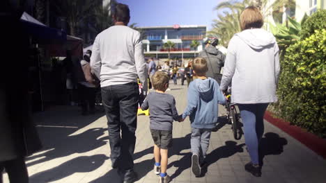 a family walking together on a sunny outdoor path