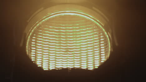 bright spotlight closeup turns on and off in dark room