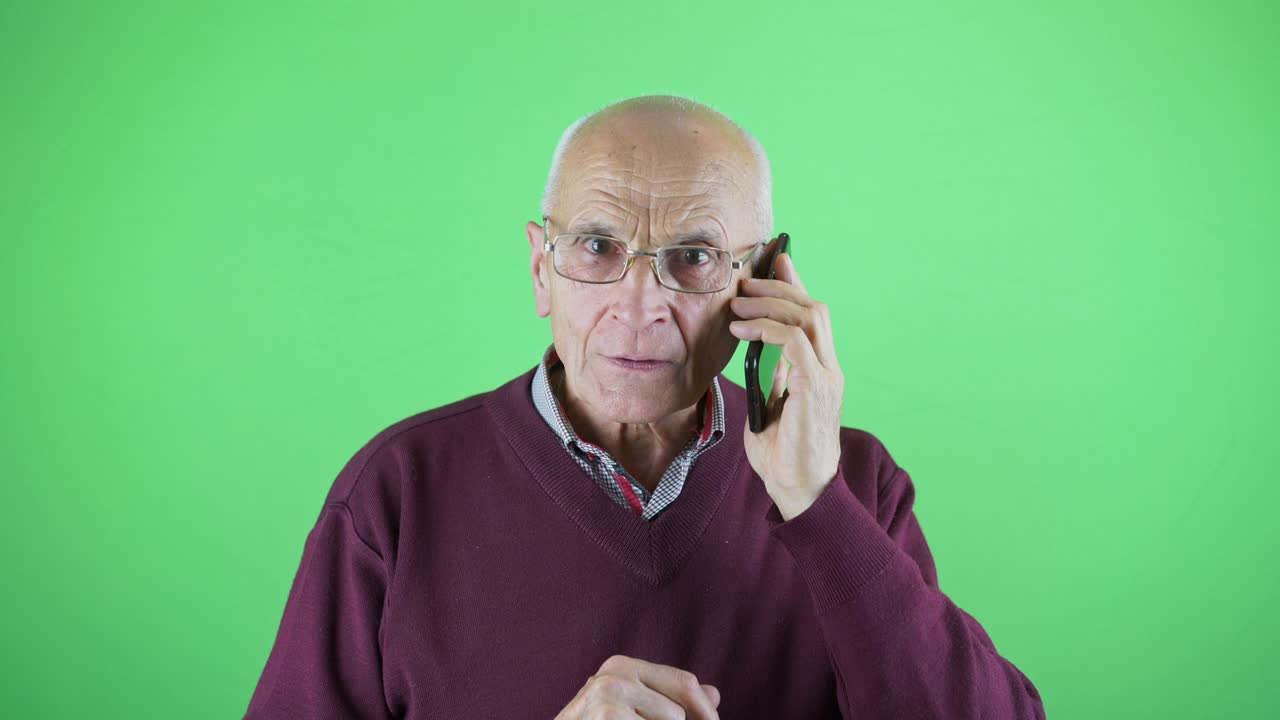 Aged person in glasses typing number and calling with smartphone