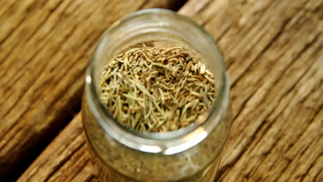 spices in jar and lid on wooden table 4k