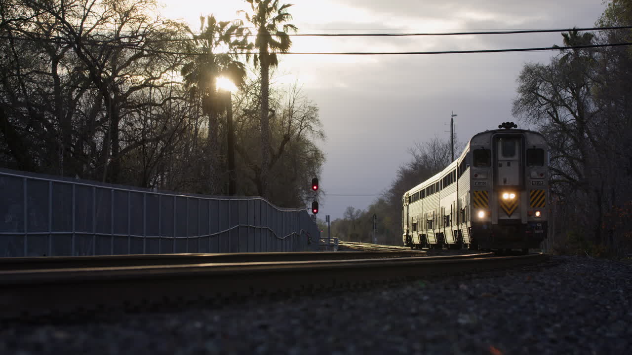 Passenger Train approaching camera during Golden Hour - UHD