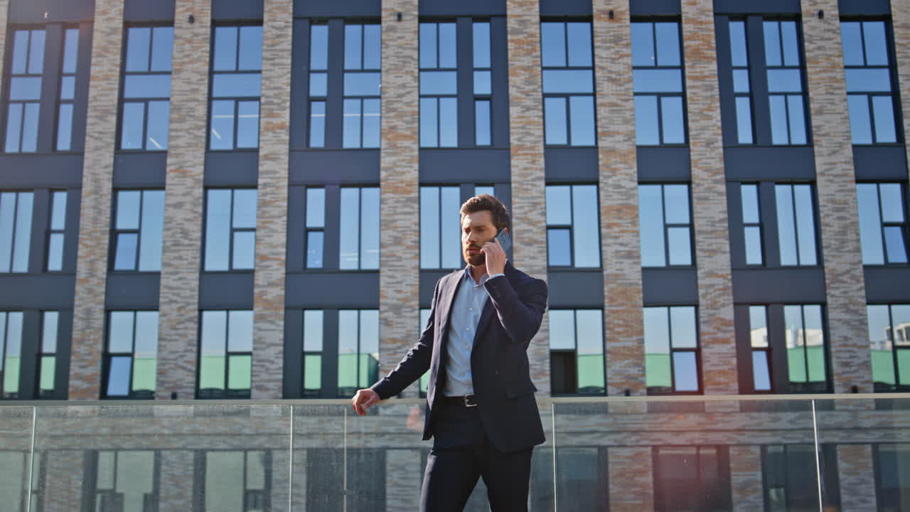 Company worker talking mobile phone standing urban business district closeup