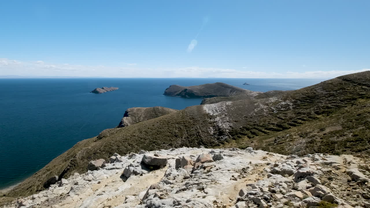 Experience the breathtaking panoramic beauty of Isla del Sol near Copacabana, Bolivia. This video captures the vast blue waters of Lake Titicaca