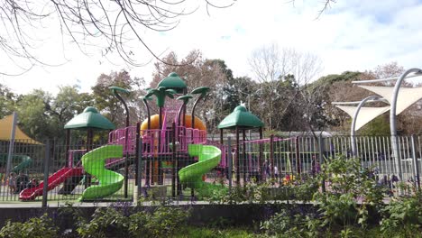 Colorful Playground with Slides and Shade Structures in a Park
