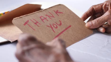 elderly person reading a handwritten thank you note