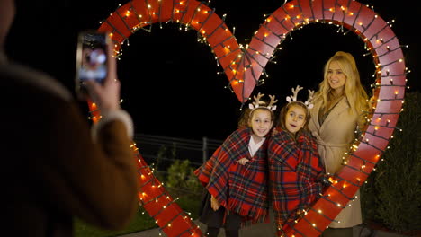 family christmas photo in heart-shaped light decoration