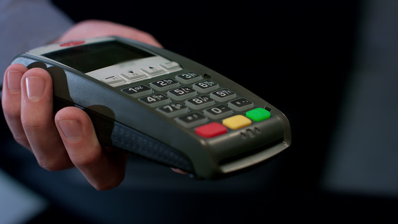 Pos terminal payment. Human hand swipe credit card in payment terminal