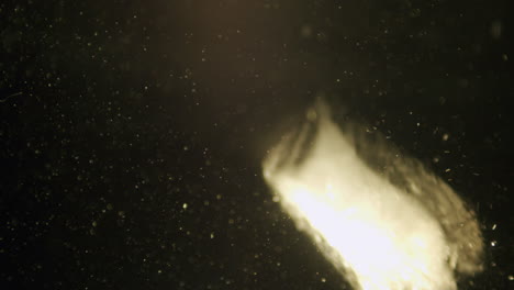 ice cube falling in water in slow motion.
