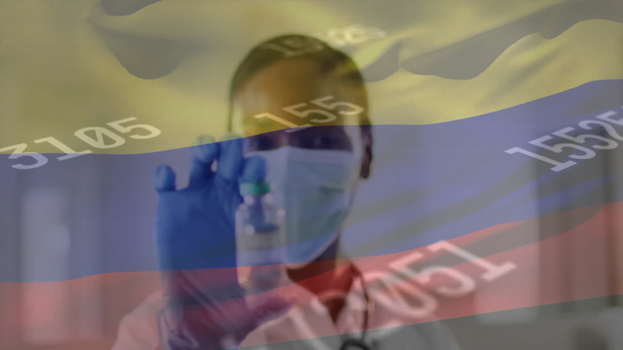 Animation of flag of colombia over african american female doctor in face mask with vaccination
