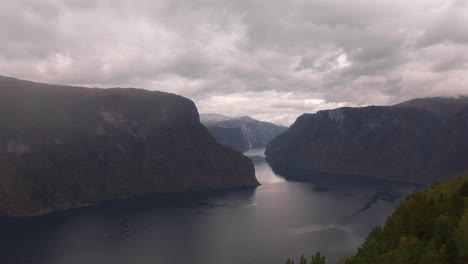 the stunning norwegian fjord, with dramatic cliffs and calm waters, aerial view