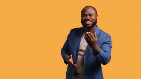 charming person having fun sending air kisses, studio background