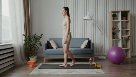 woman practicing yoga at home
