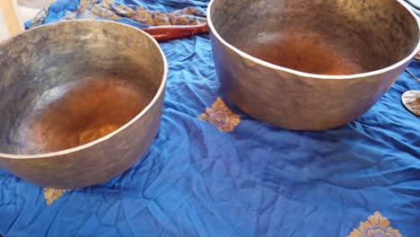 Hand-Held-Shot-of-Tibetan-Singing-Bowls-and-Tingsha-Bronze-Musical-Instruments-for-Sound-Healing