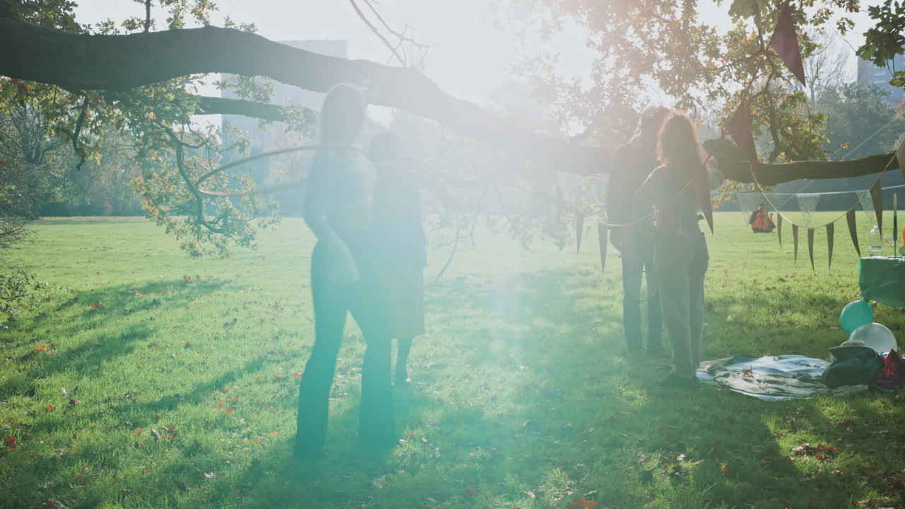Friends enjoying a hooping activity in a park