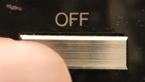 an off button is pushed by a white finger on an old or vintage vcr