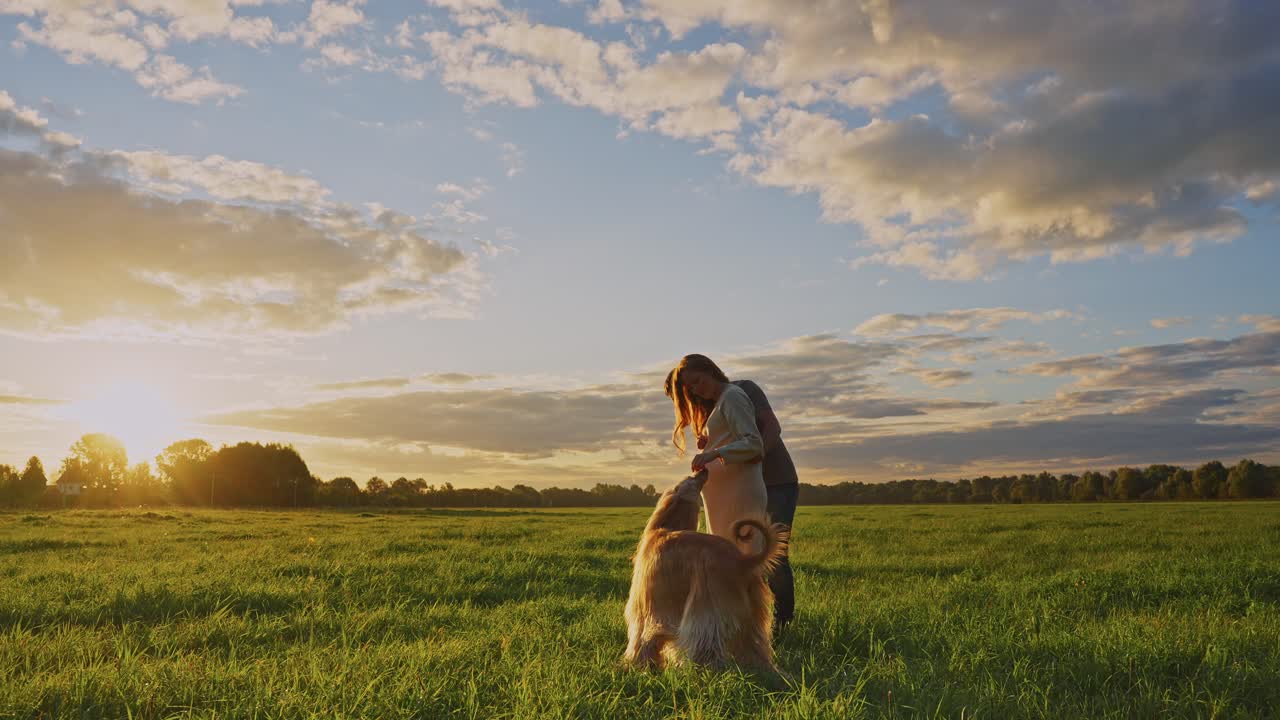 Pregnant Couple with Dog at Sunset
