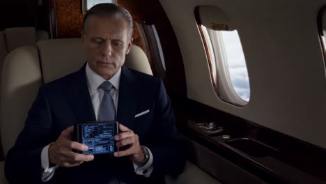 man in suit inside airplane