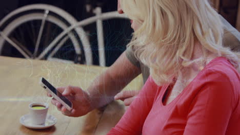 animation of connections over hands of caucasian woman and man using laptop and smartphone