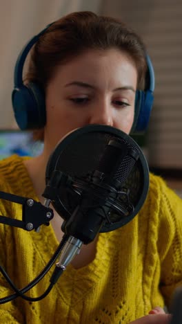 vertical video: creative blogger wearing headphones checking sound