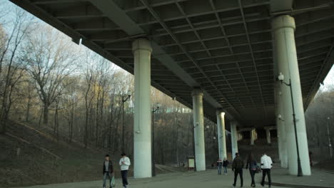 personas en borrón caminando bajo el puente