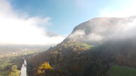 picturesque view over the countryside mountsins within clouds, transylvania, romania, pull-back orbit shot